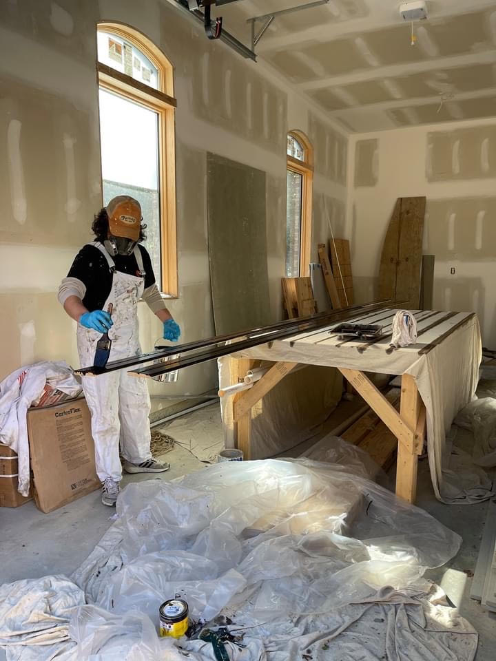 BTW painter doing stain work on a job site