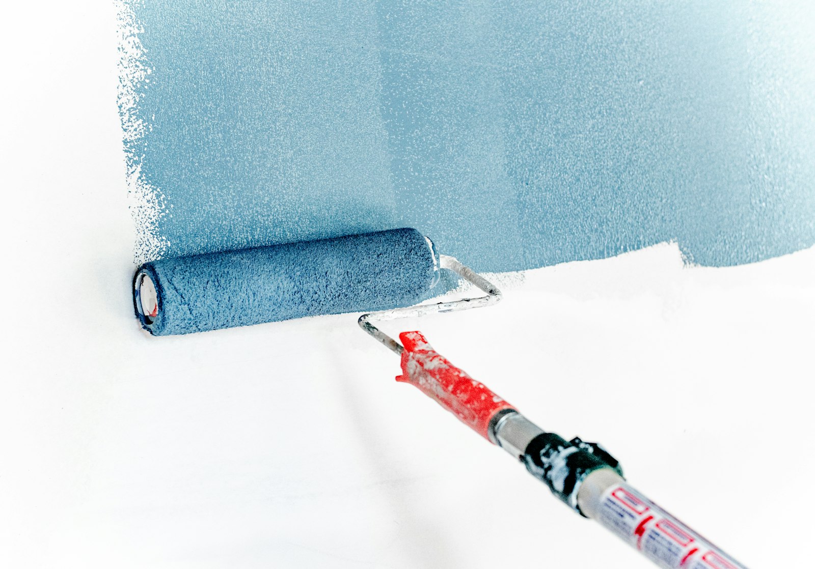 Painter rolling an interior wall